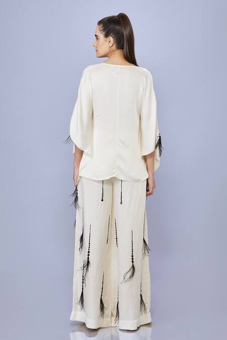 Shop Dilnaz Cream Blended Satin Embellished Feather V-neck Solid Asymmetric Short Kaftan at Aza Fashions Shop_Dilnaz_Cream Blended Satin Embellished Feather V-neck Solid Asymmetric Short Kaftan_at_Aza_Fashions