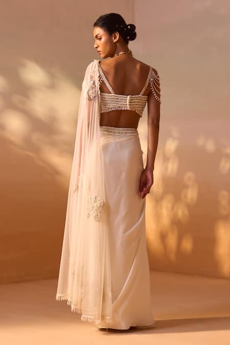 Shop Nitika Gujral Ivory Satin, Net Pearls Rosette Embroidered Pre-draped Saree With Bustier at Aza Fashions Shop_Nitika Gujral_Ivory Satin, Net Pearls Rosette Embroidered Pre-draped Saree With Bustier _at_Aza_Fashions