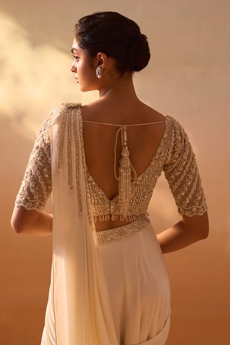 Nitika Gujral Ivory Satin, Net Pearls, Dori Tassel Embellished Pre-draped Saree With Blouse at Aza Fashions Nitika Gujral_Ivory Satin, Net Pearls, Dori Tassel Embellished Pre-draped Saree With Blouse _at_Aza_Fashions