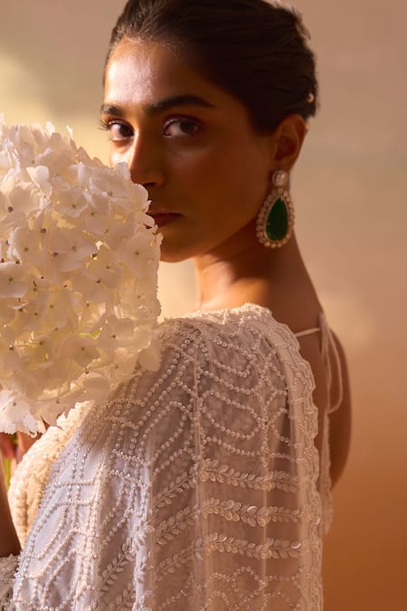 Nitika Gujral_Ivory Georgette, Satin Pearls, Sequins Cutwork Embroidered Saree With Blouse _at_Aza_Fashions