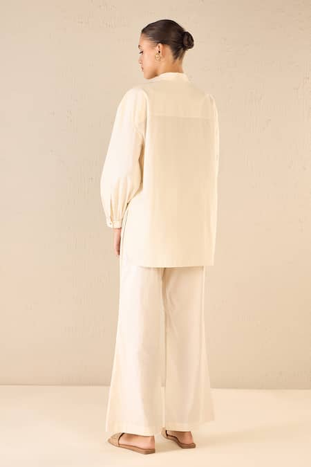 Shop Shivani Bhargava Ivory Cotton Embroidered Bead Stand Collar Rose Shirt With Flared Pant at Aza Fashions Shop_Shivani Bhargava_Ivory Cotton Embroidered Bead Stand Collar Rose Shirt With Flared Pant _at_Aza_Fashions