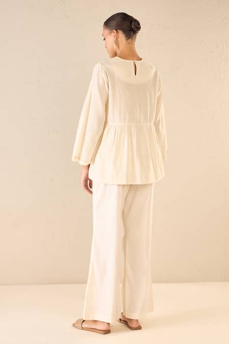 Shop Shivani Bhargava Ivory Cotton Embroidered Thread Whispering Roses Tunic Top With Flared Pant at Aza Fashions Shop_Shivani Bhargava_Ivory Cotton Embroidered Thread Whispering Roses Tunic Top With Flared Pant _at_Aza_Fashions