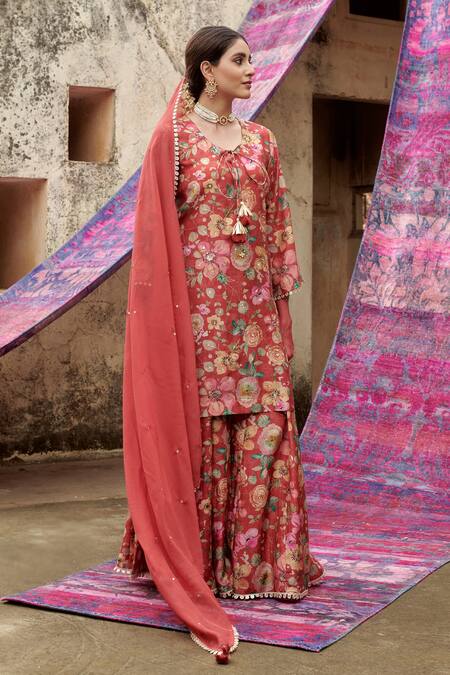 Karaj Jaipur Red Muslin, Organza Tassels, Embroidery, Sequins, Bloom Print Kurta Gharara Set at Aza Fashions Karaj Jaipur_Red Muslin, Organza Tassels, Embroidery, Sequins, Bloom Print Kurta Gharara Set _at_Aza_Fashions