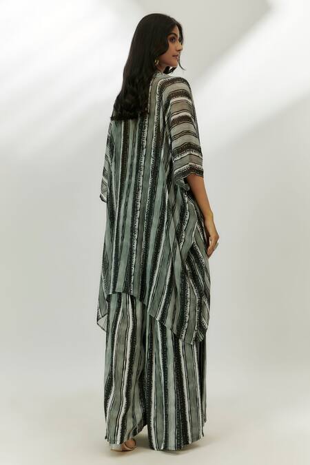 Shop Nadima Saqib Black Crepe Sequins Halter Neck Stripe Print Jumpsuit With Cape at Aza Fashions Shop_Nadima Saqib_Black Crepe Sequins Halter Neck Stripe Print Jumpsuit With Cape _at_Aza_Fashions