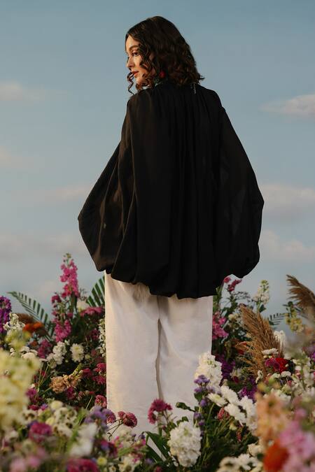 Shop Label Rama Black Muslin Solid Plunging V Neck Le Mistral Front Tie Up Cape at Aza Fashions Shop_Label Rama_Black Muslin Solid Plunging V Neck Le Mistral Front Tie Up Cape_at_Aza_Fashions