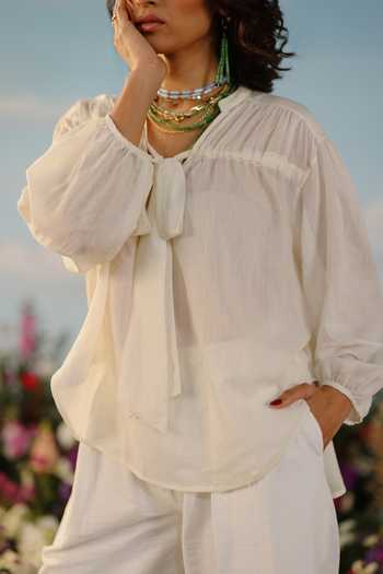 Label Rama_Off White Silk Cotton Solid Stand Collar Jasmine Peasant Sleeves Tie Up Neck Top_at_Aza_Fashions
