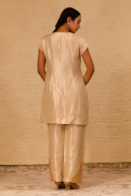 Shop Eeda Ivory Silk, Tissue Patchwork Crew Neck Center Slit Short Kurta And Pant Set at Aza Fashions Shop_Eeda_Ivory Silk, Tissue Patchwork Crew Neck Center Slit Short Kurta And Pant Set _at_Aza_Fashions