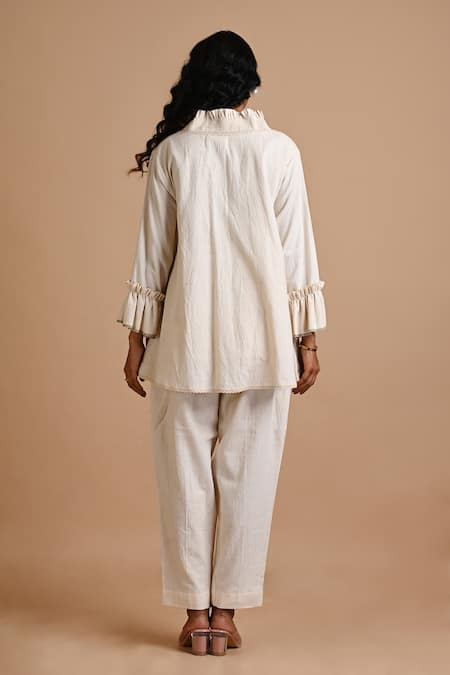 Shop Mityan Ivory Kala Cotton Hand Embroidered Floral Frilled Borage Top And Trouser Set at Aza Fashions Shop_Mityan_Ivory Kala Cotton Hand Embroidered Floral Frilled Borage Top And Trouser Set _at_Aza_Fashions