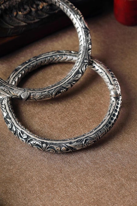 Shop Mero Jewellery Silver Plated Embroidery Floral Carved Leg Kada-Set of 2 at Aza Fashions Shop_Mero Jewellery_Silver Plated Embroidery Floral Carved Leg Kada-Set of 2 _at_Aza_Fashions