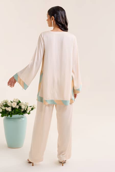 Shop Siyona By Ankurita Ivory Satin Sequins, Embroidery Round Neck Lily Short Kurta And Pant Co-ord Set at Aza Fashions Shop_Siyona By Ankurita_Ivory Satin Sequins, Embroidery Round Neck Lily Short Kurta And Pant Co-ord Set _at_Aza_Fashions