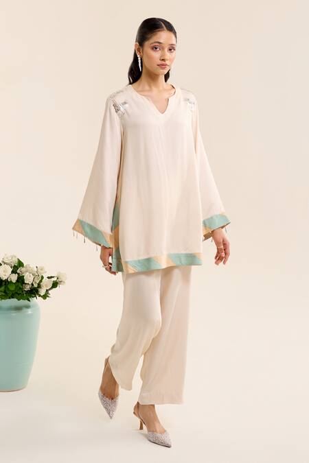 Buy Siyona By Ankurita Ivory Satin Sequins, Embroidery Round Neck Lily Short Kurta And Pant Co-ord Set Online at Aza Fashions Buy_Siyona By Ankurita_Ivory Satin Sequins, Embroidery Round Neck Lily Short Kurta And Pant Co-ord Set _Online_at_Aza_Fashions