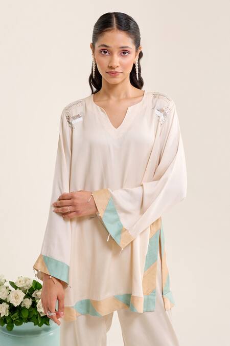 Shop Siyona By Ankurita Ivory Satin Sequins, Embroidery Round Neck Lily Short Kurta And Pant Co-ord Set Online at Aza Fashions Shop_Siyona By Ankurita_Ivory Satin Sequins, Embroidery Round Neck Lily Short Kurta And Pant Co-ord Set _Online_at_Aza_Fashions