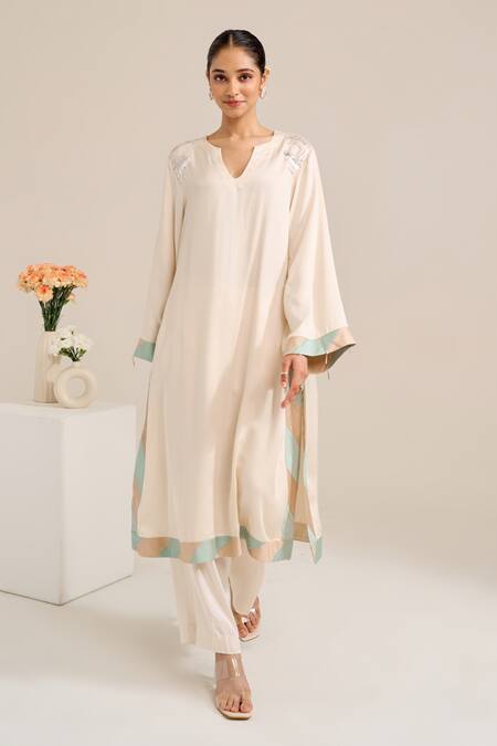 Siyona By Ankurita Ivory Satin Sequins Round Neck Lily Shoulder Embroidered Kurta Set at Aza Fashions Siyona By Ankurita_Ivory Satin Sequins Round Neck Lily Shoulder Embroidered Kurta Set _at_Aza_Fashions