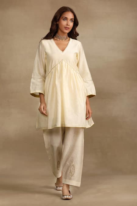 Shop Trendy Tokari Ivory Silk, Chanderi Cut Work, Embroidery, Mirrors V-neck Flared Kurta Pant Set at Aza Fashions Shop_Trendy Tokari_Ivory Silk, Chanderi Cut Work, Embroidery, Mirrors V-neck Flared Kurta Pant Set _at_Aza_Fashions