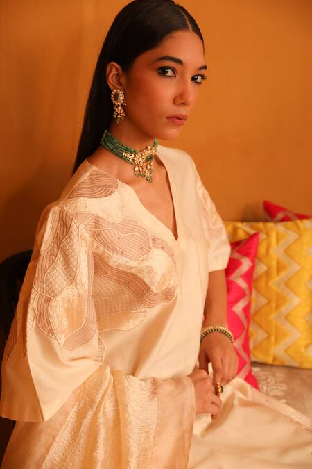 Omana By Ranjana Bothra Beige Cotton Satin, Crepe Applique, Embroidery V-neck Floral Kurta Trouser Set at Aza Fashions Omana By Ranjana Bothra_Beige Cotton Satin, Crepe Applique, Embroidery V-neck Floral Kurta Trouser Set _at_Aza_Fashions