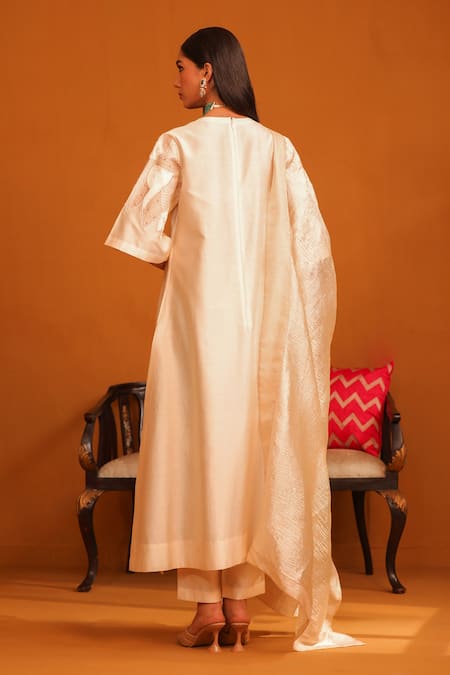 Shop Omana By Ranjana Bothra Beige Cotton Satin, Crepe Applique, Embroidery V-neck Floral Kurta Trouser Set at Aza Fashions Shop_Omana By Ranjana Bothra_Beige Cotton Satin, Crepe Applique, Embroidery V-neck Floral Kurta Trouser Set _at_Aza_Fashions