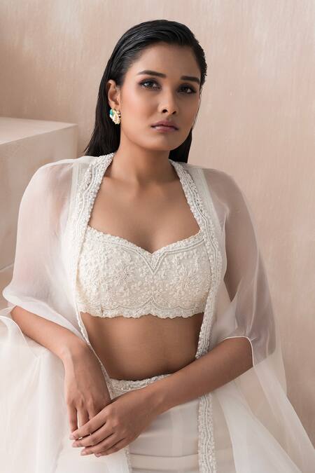 Buy Saisha Ivory Organza, Georgette Sequins, Beads, Asymmetric Cape Tiered Gharara Set Online at Aza Fashions Buy_Saisha_Ivory Organza, Georgette Sequins, Beads, Asymmetric Cape Tiered Gharara Set _Online_at_Aza_Fashions