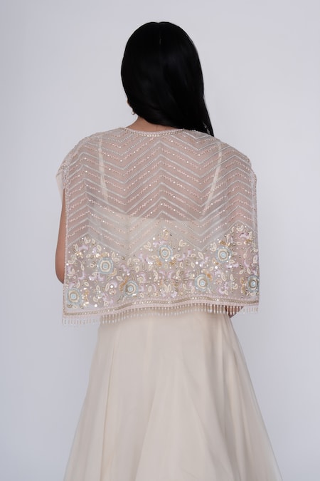 Shop Saisha Ivory Organza, Silk Sequins, Embroidery Crew Neck Floral Short Cape And Skirt Set at Aza Fashions Shop_Saisha_Ivory Organza, Silk Sequins, Embroidery Crew Neck Floral Short Cape And Skirt Set _at_Aza_Fashions