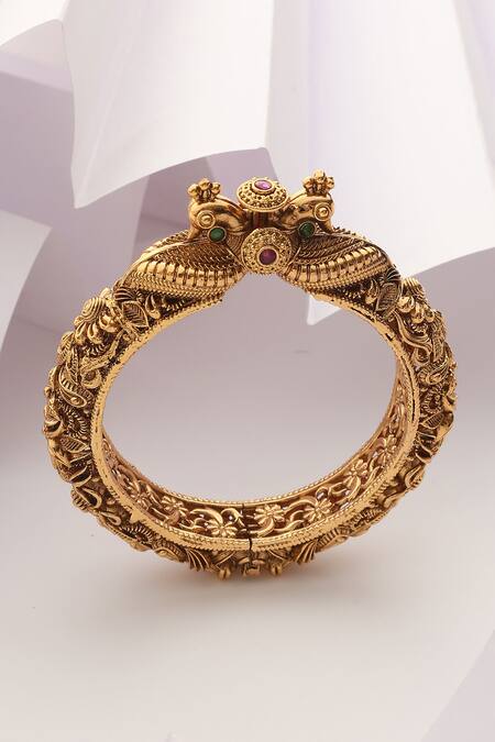 Shop SUIKALA Gold Plated Stones Carved Peacock Temple Kada at Aza Fashions Shop_SUIKALA_Gold Plated Stones Carved Peacock Temple Kada_at_Aza_Fashions