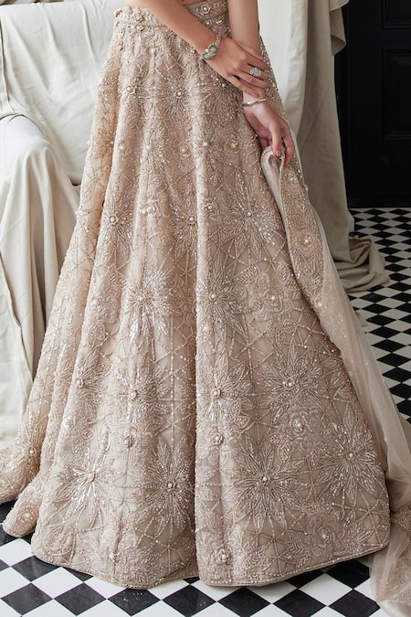 Istya Beige Net Beads, Sequins, Embroidery, Cut Floral Bridal Lehenga And Cape Set at Aza Fashions Istya_Beige Net Beads, Sequins, Embroidery, Cut Floral Bridal Lehenga And Cape Set _at_Aza_Fashions