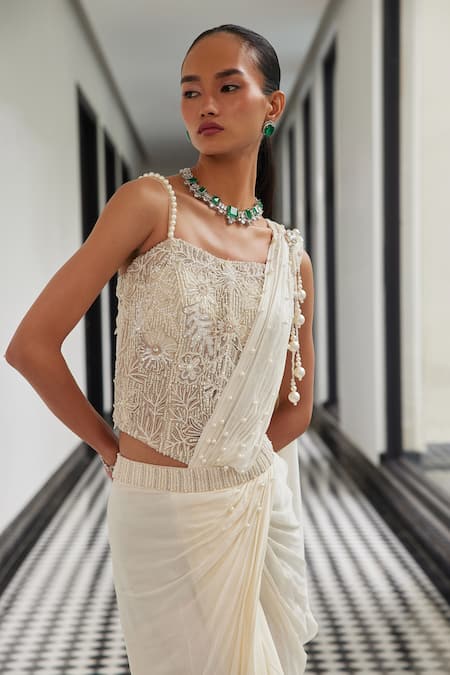 Shop Istya Ivory Chiffon Pearls, Beads, Cut Pre-draped Saree With Embroidered Corset Blouse at Aza Fashions Shop_Istya_Ivory Chiffon Pearls, Beads, Cut Pre-draped Saree With Embroidered Corset Blouse _at_Aza_Fashions