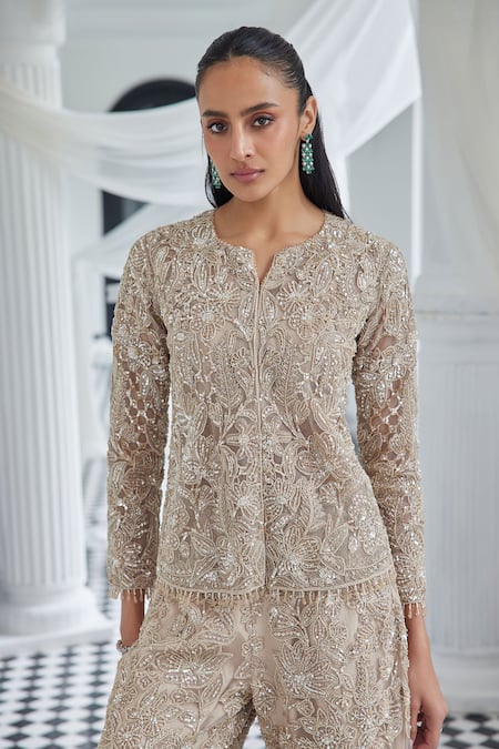 Shop Istya Beige Net Crystals Round Neck Cutdana Embroidered Jacket And Flared Pant Set at Aza Fashions Shop_Istya_Beige Net Crystals Round Neck Cutdana Embroidered Jacket And Flared Pant Set _at_Aza_Fashions