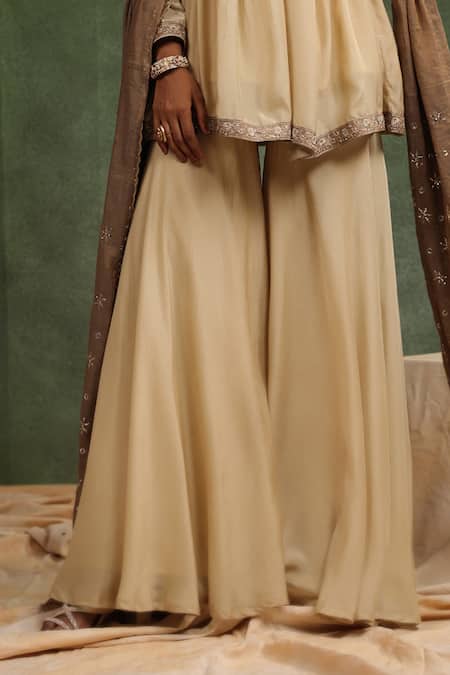 Shop Charu Makkar Beige Muslin, Silk Embroidery Over The Taupe Gathered Peplum Kurta Gharara Set Online at Aza Fashions Shop_Charu Makkar_Beige Muslin, Silk Embroidery Over The Taupe Gathered Peplum Kurta Gharara Set _Online_at_Aza_Fashions