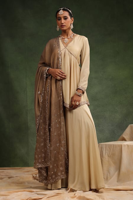 Charu Makkar Beige Muslin Silk Embroidered Over The Taupe Gathered Peplum Kurta Gharara Set 