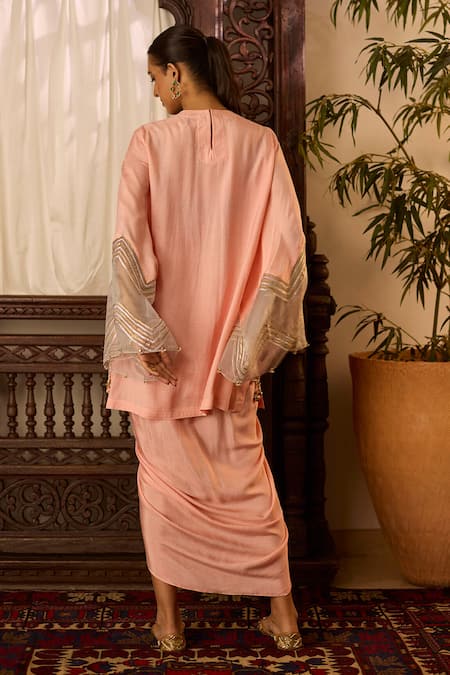 Shop Inej Peach Cotton, Silk Sequins, Zari Round Neck Embroidered Yoke Tunic And Skirt Set at Aza Fashions Shop_Inej_Peach Cotton, Silk Sequins, Zari Round Neck Embroidered Yoke Tunic And Skirt Set _at_Aza_Fashions