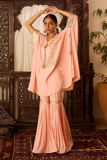 Shop Inej Peach Cotton, Silk Sequins, Tassels Round Neck Embroidered Kaftan And Gharara Set at Aza Fashions Shop_Inej_Peach Cotton, Silk Sequins, Tassels Round Neck Embroidered Kaftan And Gharara Set _at_Aza_Fashions