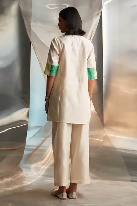 Shop Charkhee Ivory Chanderi Embroidered Zari Round Short Kurta Pant Set at Aza Fashions Shop_Charkhee_Ivory Chanderi Embroidered Zari Round Short Kurta Pant Set _at_Aza_Fashions