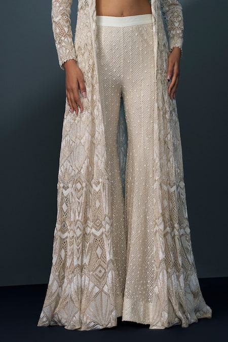Ritika Mirchandani Ivory Crepe Embellished Crystal Coat Lapel Zephyra Cutwork Trench Sharara Set Online at Aza Fashions Ritika Mirchandani_Ivory Crepe Embellished Crystal Coat Lapel Zephyra Cutwork Trench Sharara Set _Online_at_Aza_Fashions