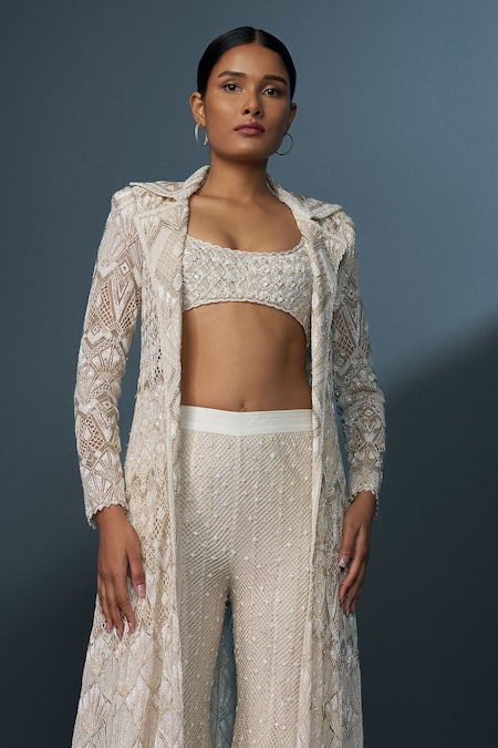 Shop Ritika Mirchandani Ivory Crepe Embellished Crystal Coat Lapel Zephyra Cutwork Trench Sharara Set Online at Aza Fashions Shop_Ritika Mirchandani_Ivory Crepe Embellished Crystal Coat Lapel Zephyra Cutwork Trench Sharara Set _Online_at_Aza_Fashions