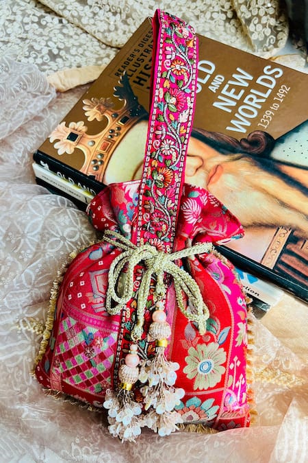 Shop Fuchsia by aashaka mehta Pink Embroidery, Tassels Silk Floral Woven Potli at Aza Fashions Shop_Fuchsia by aashaka mehta_Pink Embroidery, Tassels Silk Floral Woven Potli _at_Aza_Fashions