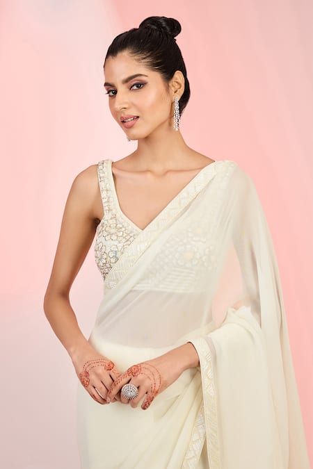 Meenagurnam_Ivory Georgette, Net Sequins, Beads, Cutdana Embellished Hem Saree With Blouse _Online_at_Aza_Fashions