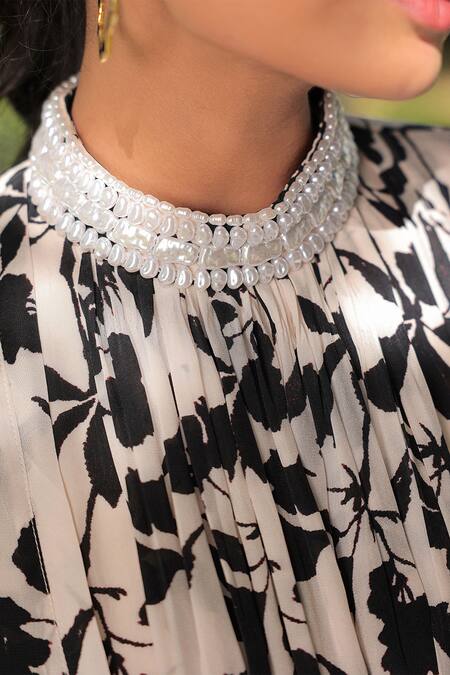 Meher By Islie White Crepe Pearls Round Neck Ebony Bloom Print Harem Jumpsuit at Aza Fashions Meher By Islie_White Crepe Pearls Round Neck Ebony Bloom Print Harem Jumpsuit _at_Aza_Fashions