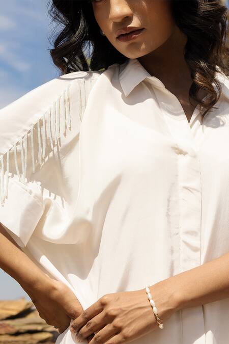 Meher By Islie Ivory Crepe Beads Shawl Neck Jazzy Tassels Embellished Shirt Dress Online at Aza Fashions Meher By Islie_Ivory Crepe Beads Shawl Neck Jazzy Tassels Embellished Shirt Dress _Online_at_Aza_Fashions