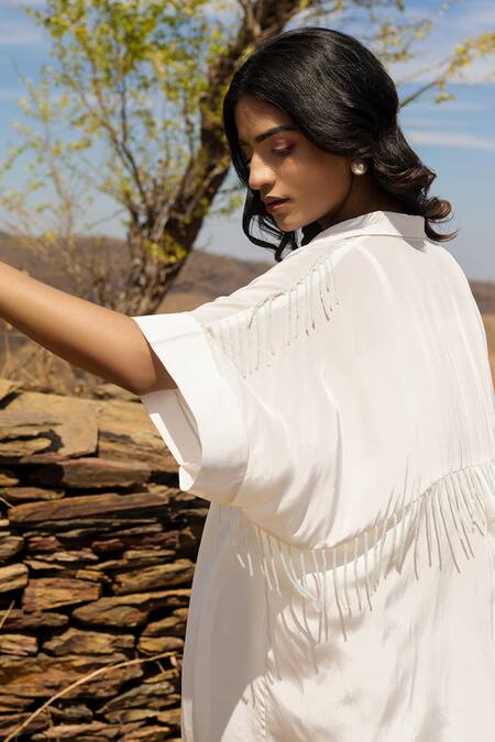 Buy Meher By Islie Ivory Crepe Beads Shawl Neck Jazzy Tassels Embellished Shirt Dress Online at Aza Fashions Buy_Meher By Islie_Ivory Crepe Beads Shawl Neck Jazzy Tassels Embellished Shirt Dress _Online_at_Aza_Fashions