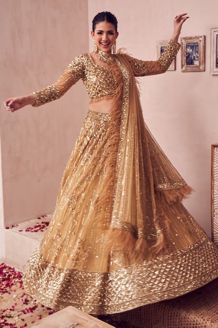 Swish By Dolcy And Simran Gold Net, Linen Beads, Feathers, Dripping Gul Embroidered Bridal Lehenga Set at Aza Fashions Swish By Dolcy And Simran_Gold Net, Linen Beads, Feathers, Dripping Gul Embroidered Bridal Lehenga Set _at_Aza_Fashions