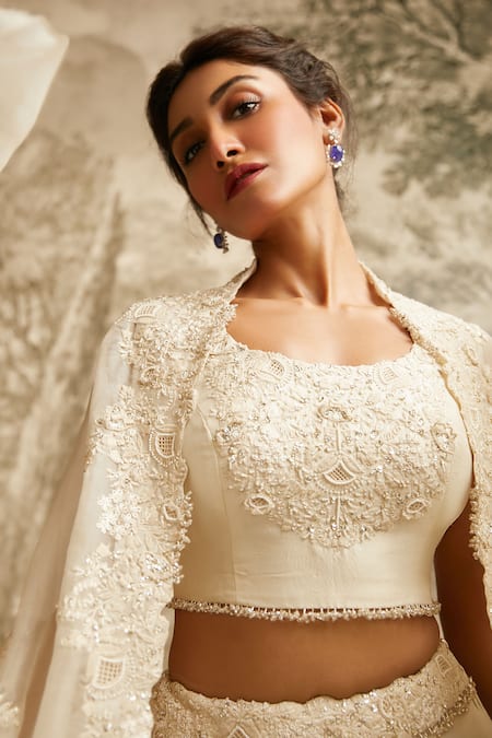 Shop Prisho Ivory Silk, Organza Tonal Resham Embroidered Asymmetric Cape Lehenga Set at Aza Fashions Shop_Prisho_Ivory Silk, Organza Tonal Resham Embroidered Asymmetric Cape Lehenga Set _at_Aza_Fashions