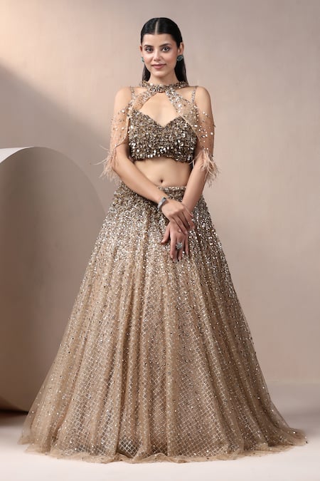 Chaashni by Maansi and Ketan Gold Net Embroidered Pearl Blouse Plunge Lehenga Set With Cape 