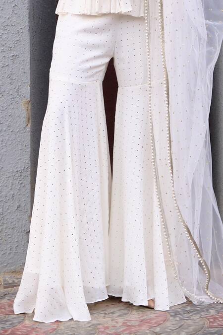 Chamee And Palak Ivory Georgette, Net, Silk, Tulle Pearls, Nyra Embroidered Peplum Sharara Set at Aza Fashions Chamee And Palak_Ivory Georgette, Net, Silk, Tulle Pearls, Nyra Embroidered Peplum Sharara Set _at_Aza_Fashions