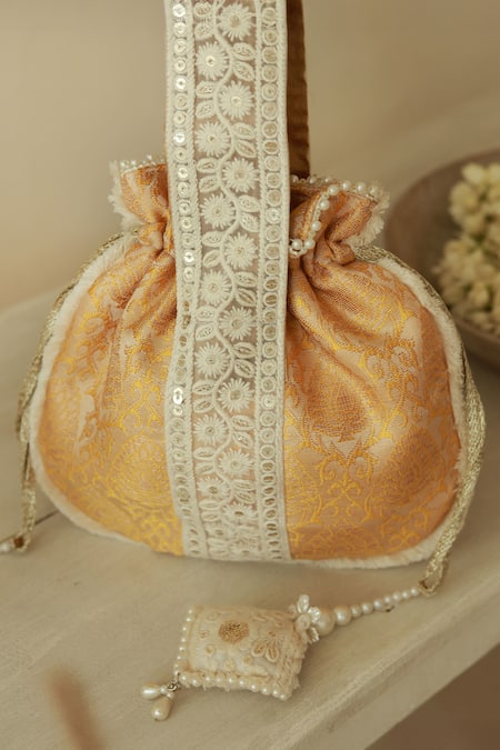 The Tan Clan Yellow Thread Ruhi Embroidered Potli Bag at Aza Fashions The Tan Clan_Yellow Thread Ruhi Embroidered Potli Bag _at_Aza_Fashions
