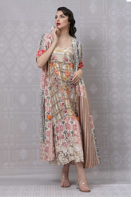 Niki Mahajan Beige Crepe Tassels Round Neck Geometric Floral Print Dress With Cape at Aza Fashions Niki Mahajan_Beige Crepe Tassels Round Neck Geometric Floral Print Dress With Cape _at_Aza_Fashions