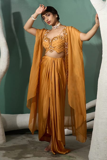 One Knot One By Ashna Yellow Silk Satin, Crepe Marigold Flora Embroidered Cape Draped Skirt Set at Aza Fashions One Knot One By Ashna_Yellow Silk Satin, Crepe Marigold Flora Embroidered Cape Draped Skirt Set _at_Aza_Fashions