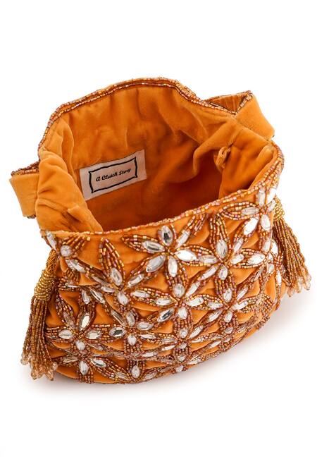 Shop_A Clutch Story_Gold Crystals, Cut Work, Beads Gardenia Embellished Potli _Online_at_Aza_Fashions