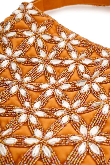 A Clutch Story_Gold Crystals, Cut Work, Beads Gardenia Embellished Potli _at_Aza_Fashions