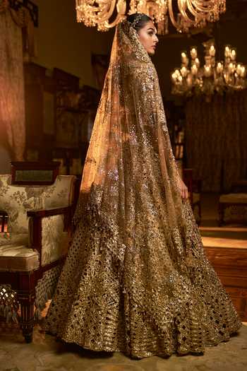 Shop_Seema Gujral_Gold Net Sequins, Zari, Tassels, Embroidery Floral Cutwork Bridal Lehenga Set _Online_at_Aza_Fashions