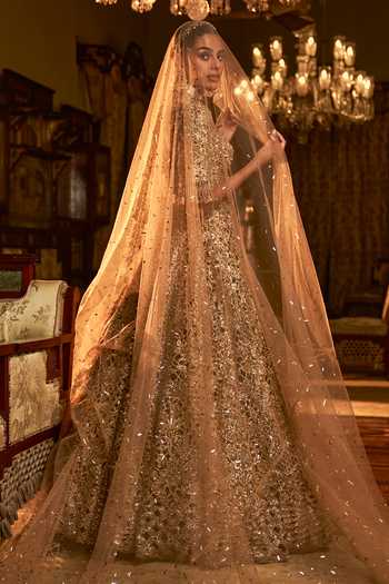 Seema Gujral_Gold Net Sequins, Zari, Tassels, Embroidery Floral Cutwork Bridal Lehenga Set _at_Aza_Fashions