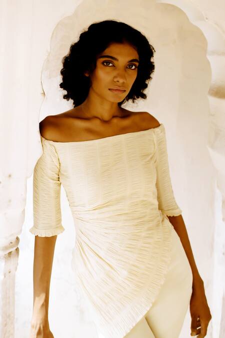 Buy Zwaan Ivory Cotton Off-shoulder Ivy Smocked Asymmetric Top Online at Aza Fashions Buy_Zwaan_Ivory Cotton Off-shoulder Ivy Smocked Asymmetric Top _Online_at_Aza_Fashions